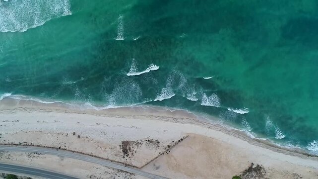 Beautiful aerial view of white sandy beach and crystal clear turquoise water on Kish Island.