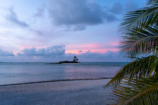 Sunset over a tropical motu on Tikehau Atoll, French Polynesia