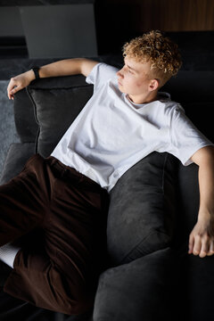 Man in his early twenties relaxing and dreaming of adventures
