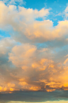 Golden evening dramatic sunset sky background - picturesque colorful clouds landscape lit by sunlight