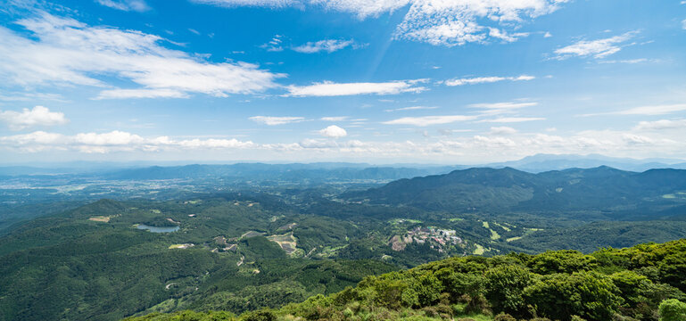 Panoramic aerial view of Beppu city and Beppu bay under blue sky with clouds from mountain viewpoint in Oita Japan