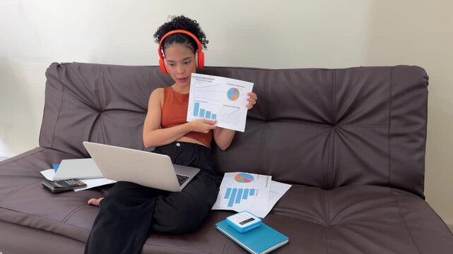 Young businesswoman presenting financial data during video conference