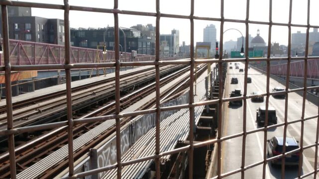 Williamsburg Bridge in Brooklyn, New York City United States. Transport metallic bridge pedestrian path near Marcy Av subway station and Domino park in Williamsburg. Queens and Bronx road traffic sign