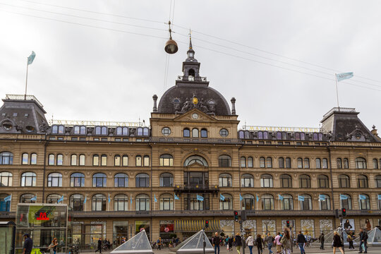 View of the historic Magasin du Nord department store building with its ornate facade, central dome, and bustling street level in Copenhagen, Denmark.