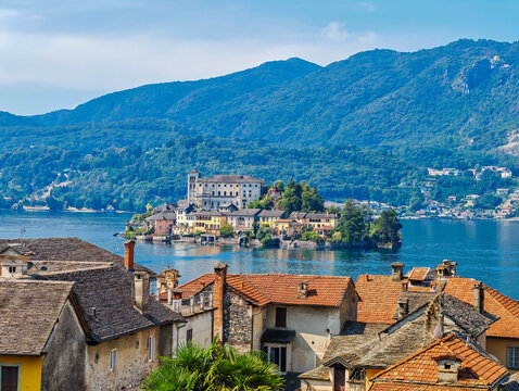 San Giulio Island on Lake Orta, Piedmont, Italy. Aerial panoramic view featuring the historic basilica and picturesque lakeside scenery surrounded by Alpine landscapes