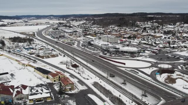 Aerial view of snowy roads, railway, and buildings in Alvangen during winter