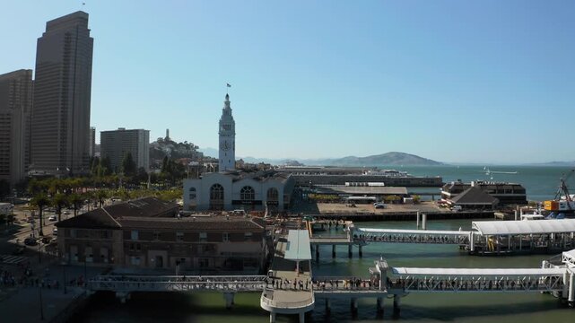 Drone Aerial Flying Over Docks Towards Historic Ferry Building Clock Tower Revealing Alcatraz and Angel Island Beyond - (UHD 4K)