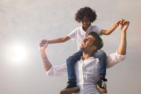 Father carrying son on his shoulder during leisure period