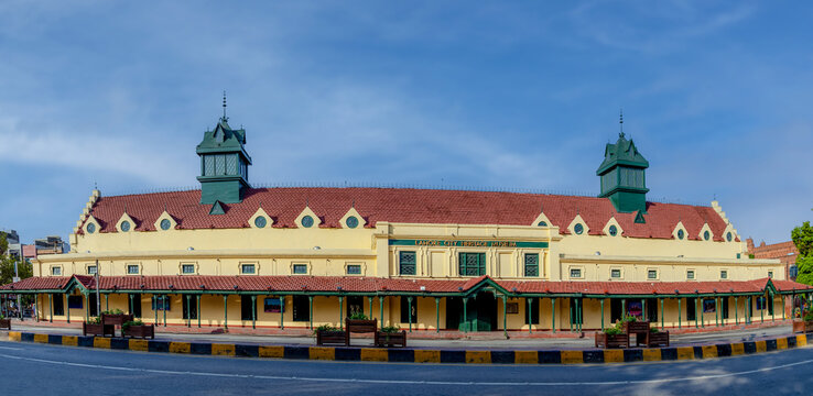 View of the historic Old Tollinton Market, now the Lahore City Heritage Museum, featuring its distinctive red-tiled roof and green towers under a clear blue sky in Lahore, Punjab, Pakistan.
