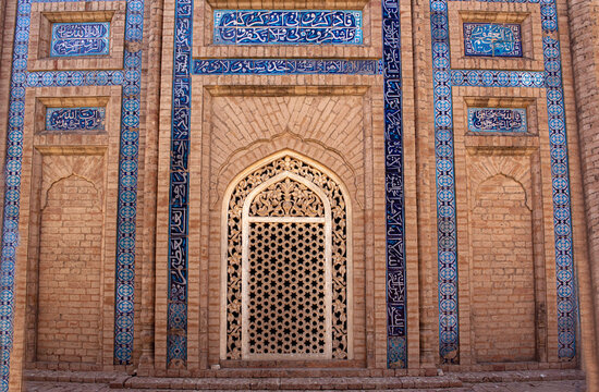 View of the intricate blue tile work and brick masonry of the historic Abbasi Royal Graveyard, featuring ornate arched entrances and geometric patterns in Derawar, Punjab, Pakistan.