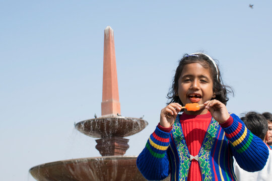 cheerfull girl eating ice-cream showing colourful teeth
