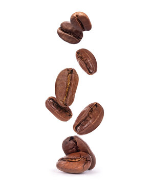 Falling coffee beans close-up isolated on a white background