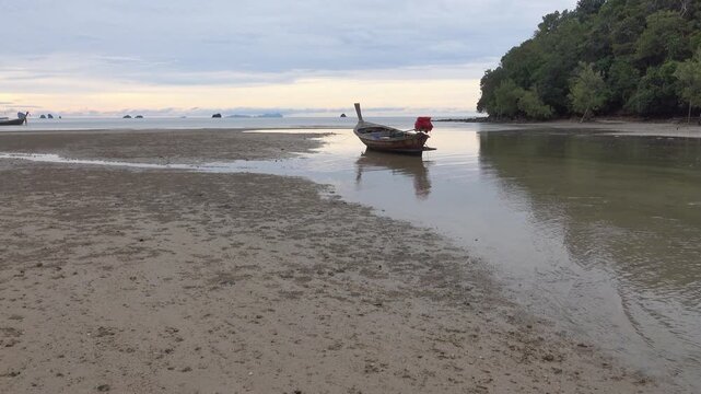 Traditional Thai sea boats at low tide on the Andaman Sea