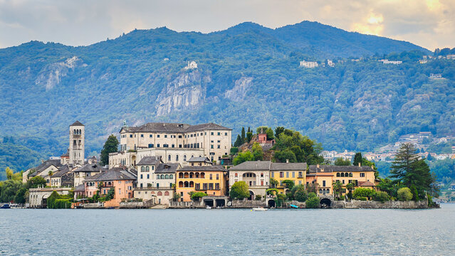 Panoramic view of San Giulio Island on Lake Orta, Piedmont, Italy, featuring the historic basilica and picturesque lakeside scenery surrounded by Alpine landscapes
