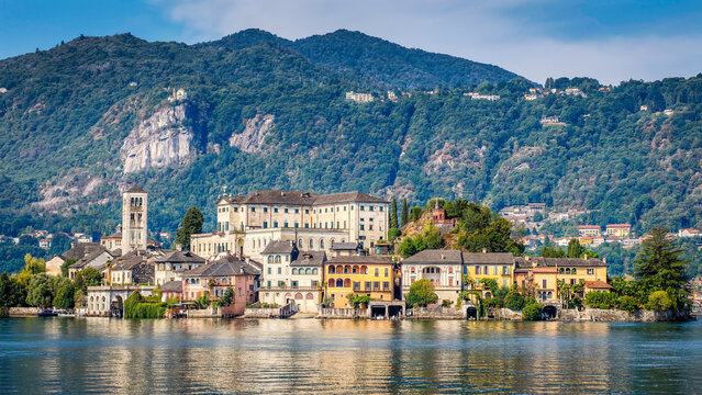 Panoramic view of San Giulio Island on Lake Orta, Piedmont, Italy, featuring the historic basilica and picturesque lakeside scenery surrounded by Alpine landscapes