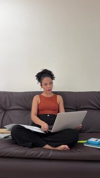 Young latina student participating in online class
