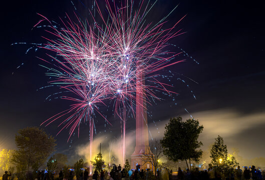 View of colorful fireworks bursting in the night sky above the Charing Cross monument in Lahore, Punjab, Pakistan.