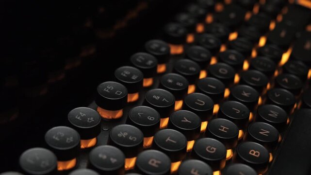 Review of black gaming computer keyboard with round LED backlight keys in dark close-up