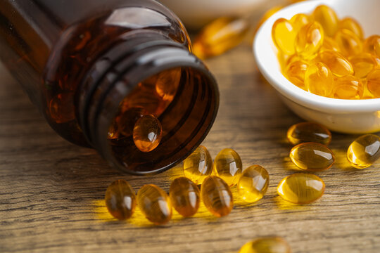 Fish oil or Cod liver oil gel in capsules with omega 3 vitamins, supplementary healthy food.