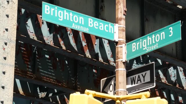 New York City Brighton sign and elevated subway, metropolitan bridge, metro track above street. Railway transport over road. Railroad line, one way. Coney Island Brighton beach avenue, United States.