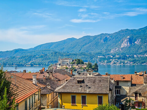 Panoramic view of Orta San Giulio on the shores of Lake Orta, Piedmont, Italy. Aerial drone view showcasing the historic lakeside town and picturesque Alpine landscape