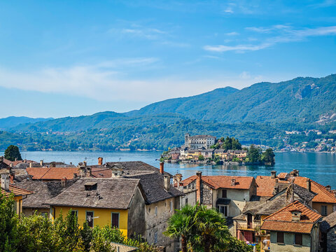 Panoramic view of San Giulio Island on Lake Orta, Piedmont, Italy, featuring the historic basilica and picturesque lakeside scenery surrounded by Alpine landscapes