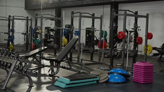 Gym equipment standing in empty fitness center. Clip is perfect for marketing health clubs, personal training programs, or athletic lifestyle brands