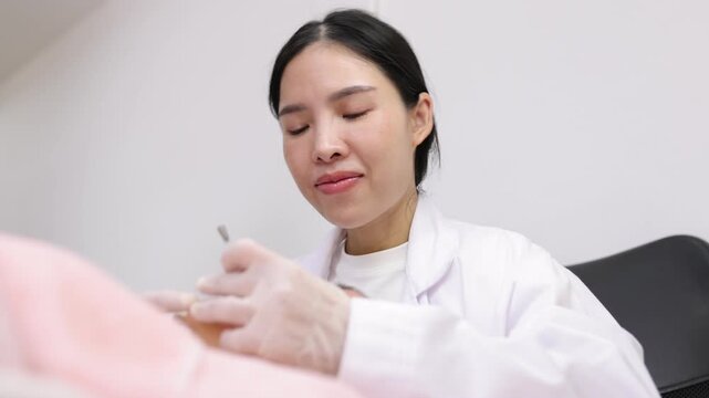 Dermatologist performing acne extraction on a patient's face.