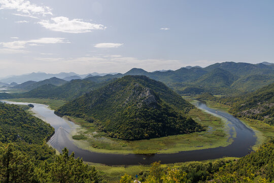 Winding river canyon with green mountains aerial view