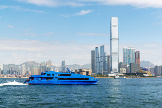 Hong Kong skyscraper panorama on a sunny day with water and boats