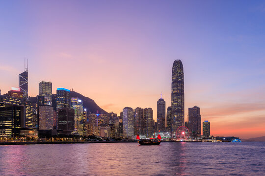 Hong Kong city skyline at sunset with glowing sky and skyscrapers