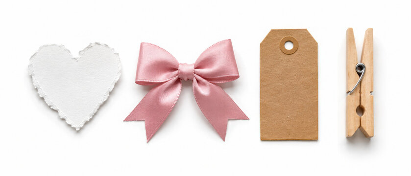 White paper heart, pink satin ribbon bow, blank kraft tag and wooden clothespin isolated on transparent background. Gift wrapping and craft set.