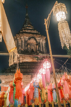 View of the ancient Wat Lok Moli temple illuminated by colorful traditional Lanna lanterns at night in Chiang Mai, Chiang Mai, Thailand.
