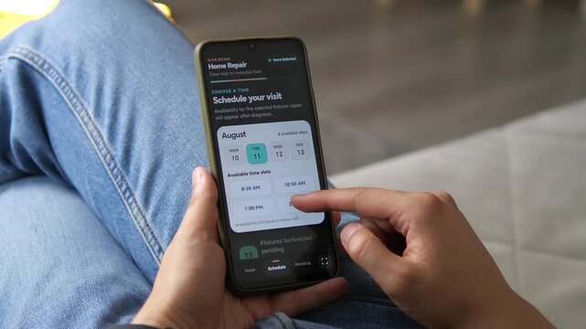 Person uses a smartphone to select a household repair issue, compare service options and schedule a technician, reflecting the growth of digital home maintenance platforms.