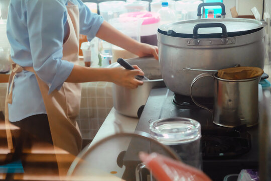 Close up Image of Woman preparing food at the stove
