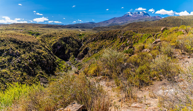 A view along a gully towards the Chachani volcano from a Colca Canyon viewpoint in the Andes mountains of Peru in the dry season