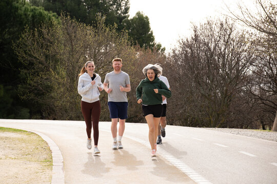 Group of diverse people enjoying a good run together in a park
