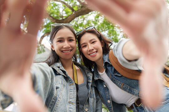 POV shot of happy Asian women tourists smiling during vacation trip outdoors