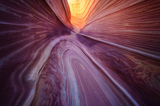 View of The Wave sandstone rock formations with swirling red and orange patterns in Kanab, Arizona, United States.