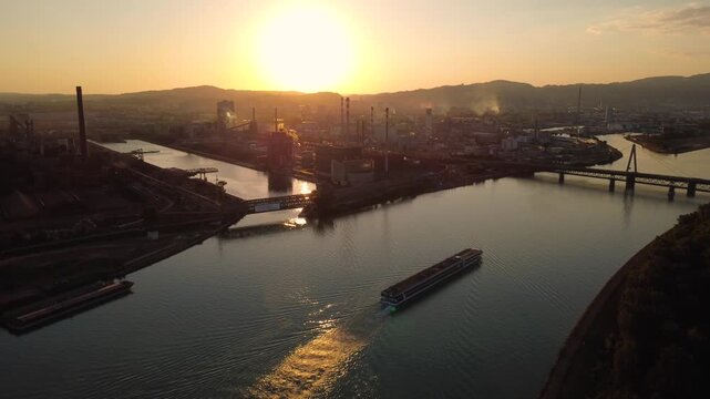 River cruise ship on the danube in Linz at sunset with industry