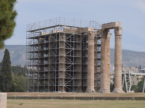 View of the Temple of Olympian Zeus surrounded by metal scaffolding for restoration work in Athens, Greece.