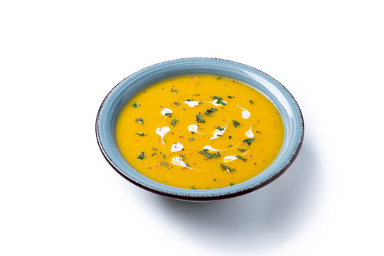 Creamy pumpkin soup isolated on white background
