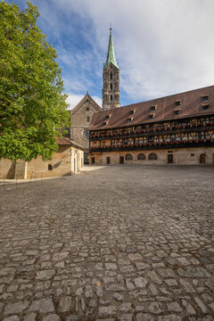 20 August 2026, The historic cobblestone courtyard of Alte Hofhaltung with the Bamberg Cathedral spire visible in Bamberg, Germany.
