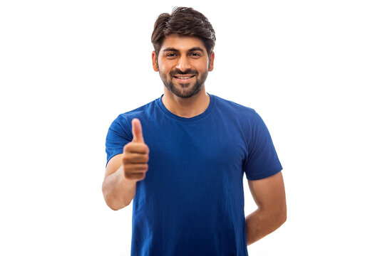 A YOUNG MAN SHOWING THUMBS UP IN FRONT OF CAMERA