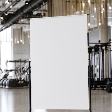 Blank white banner stand in modern gym with exercise equipment