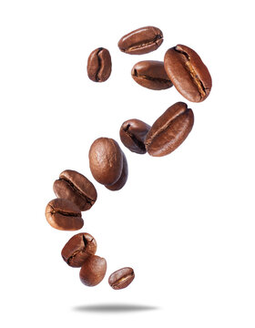 Falling roasted coffee beans in the air close-up isolated on a transparent background