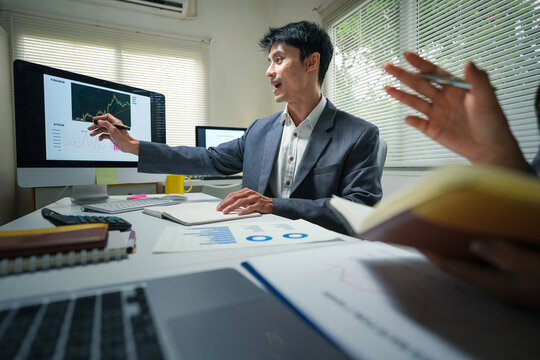 Business Analyst Presenting Financial Chart in Office