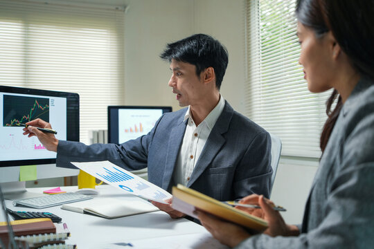 Business team analyzing financial charts in office