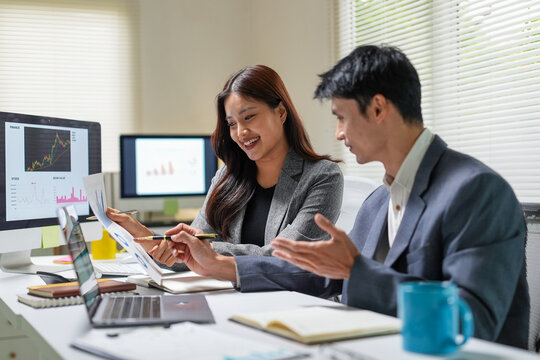 Business Team Discussing Financial Charts in Office