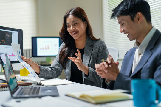Business Team Discussing Financial Charts in Office